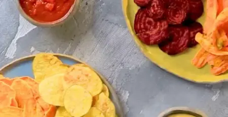 Vegetable chips with tomato dip and cheddar sauce